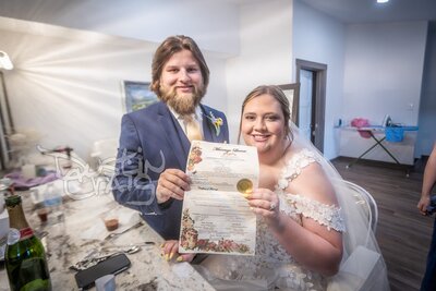 Bride and groom with officiant during wedding ceremony