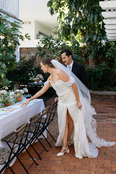 Bride and groom admiring their wedding reception space and elegant details, captured by a La Jolla wedding photographer.
