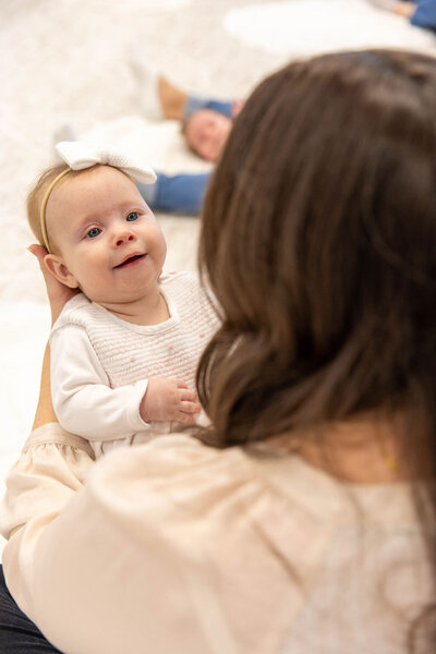 Baby smiling while being held
