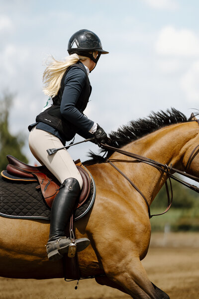 a bay horse with an english rider on course at an Ontario Trillium show captured by a equine private client photographer based in Ontario