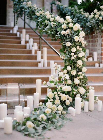 Ivory Candles and White Roses on a staircase outside