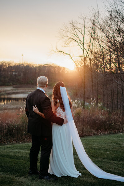 wedding couple looking at the sunset after they said "I do" in St. Charles, IL