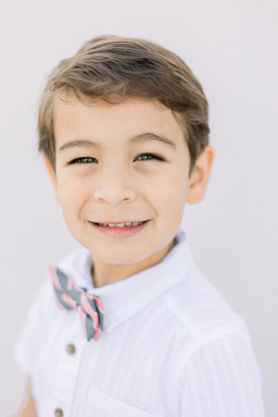 mom and dad holding newborn baby with soft white and neutral color pallette taken by Newborn Photographer Sacramento Kelsey Krall