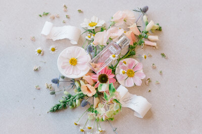 Perfume surrounded by colorful wedding florals for a wedding at Warwick Country club Rhode Island