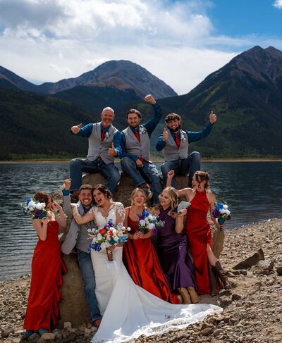 a couple holding one another while walking during sunset taking photos at their wedding 