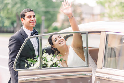 bride and groom smile at each other leaning forehead to forehead with eyes closed