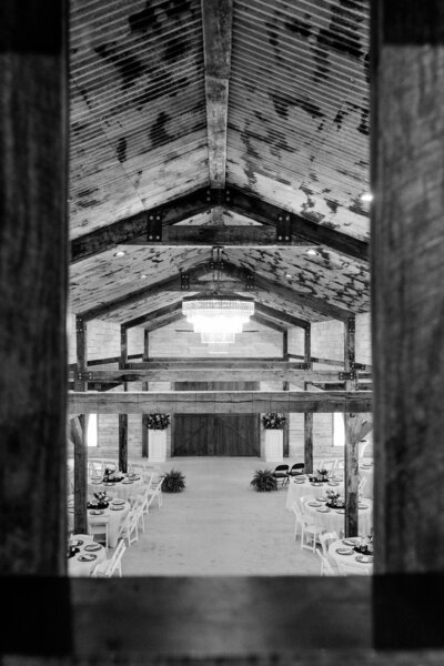 Indoor reception setup at The Grove with farmhouse tables, elegant lighting, and western-modern décor.