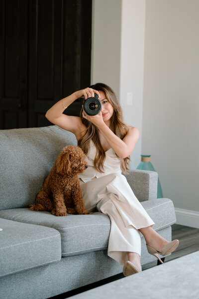 Documenting love from every angle. Jess holds a camera up while a dog sits next to her. 