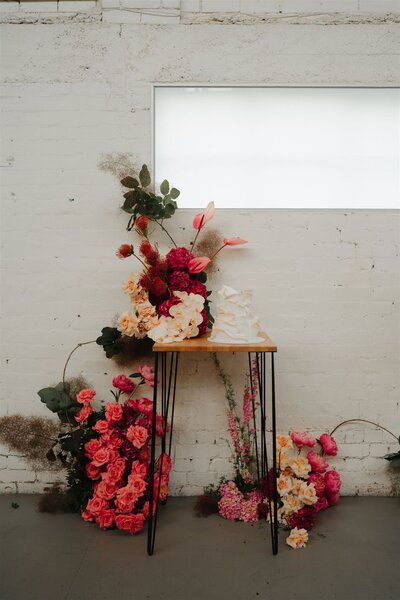 colourful wedding florals and layered cake at the wool mill in Fitzroy
