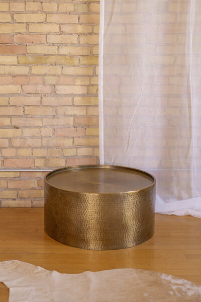 A round brass coffee table.