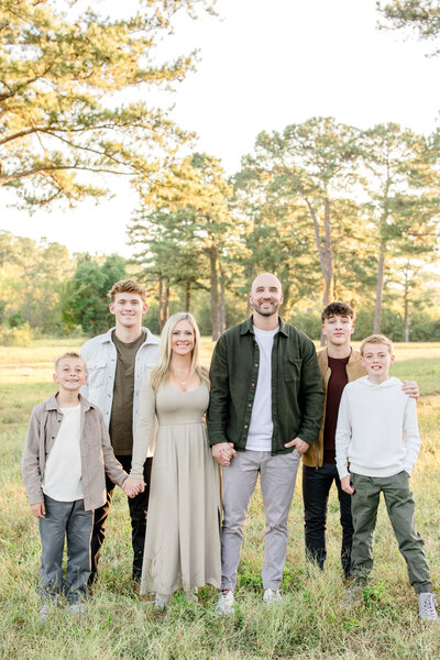 Hopeful adoptive family smiling together during a fall park photoshoot, showing love, stability, and readiness for adoption.