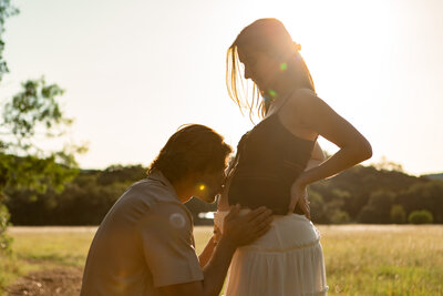 sonogram maternity photography gorgeous pregnant mom holding her ultrasound photos in a field