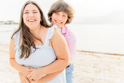 Teenage boy hugging his sister from behind