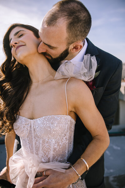 Bride and groom on a sunny day on a rooftop of the strip district of Pittsburgh.