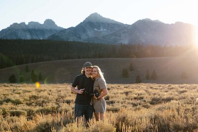 Lauren and Matt from Intimate Adventures Media standing in front of the Sawtooth mountain range in Stanley, Idaho