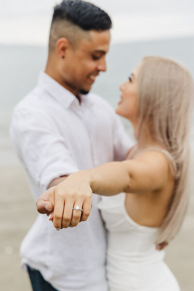 engaged couple on beach