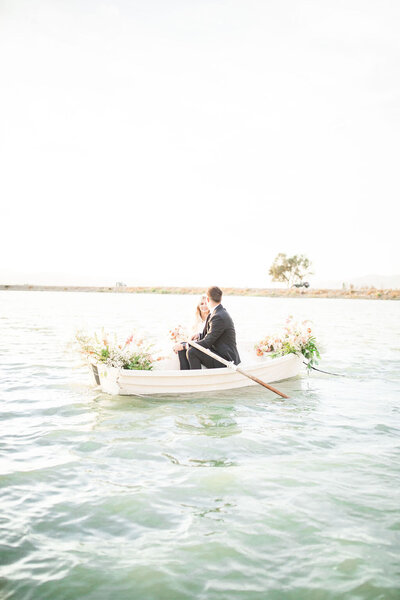 bride and groom flowers in a boat