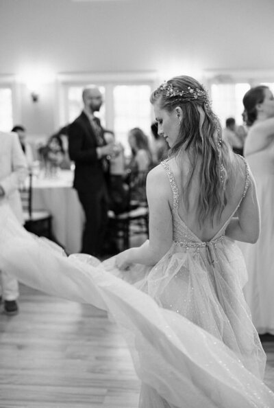 Bride at wedding reception with dress flowing