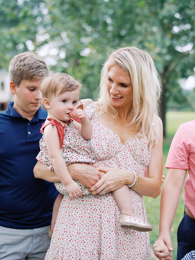 A woman looking at and holding a baby at a Richmond mini session by Katie Stansfield Photography.