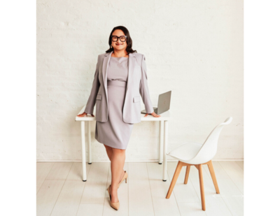 Dra. Aurora Chang standing in front of a desk with a laptop on it