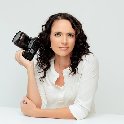 Alyson Berg, Los Angeles photographer, serious and confident for photo holding her camera