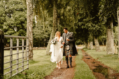 Bride and Groom kissing under neaon sign at alternative scotland wedding