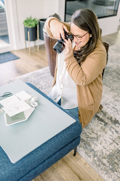 Headshot of Cat Alkire Holding Nikon Camera and smiling