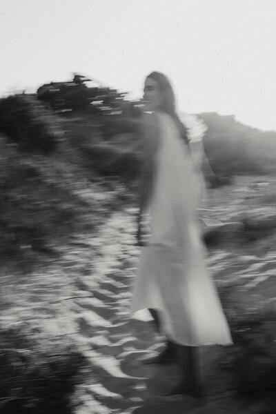 a blurred white and black and white portrait of a girl wearing a white dress