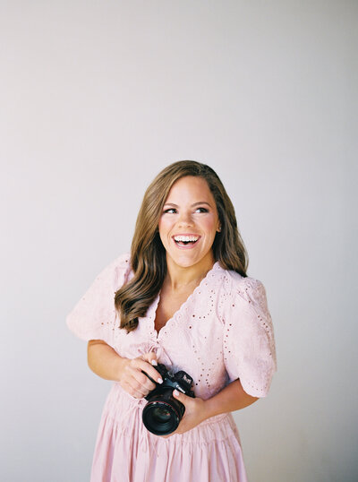 Claire Hodges smiling with her camera