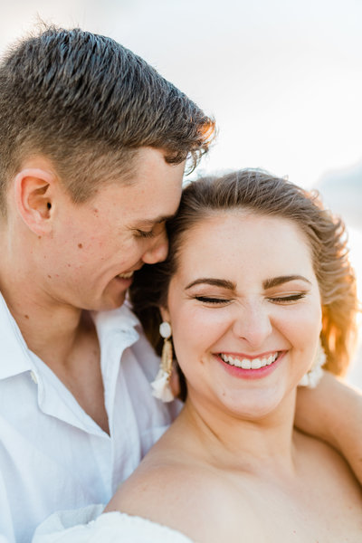 couple laughing together during laguna beach engagement photos