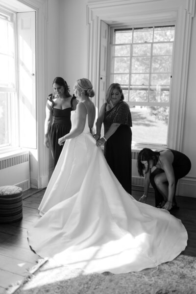 bride getting her wedding dress on at her upstate new york wedding 