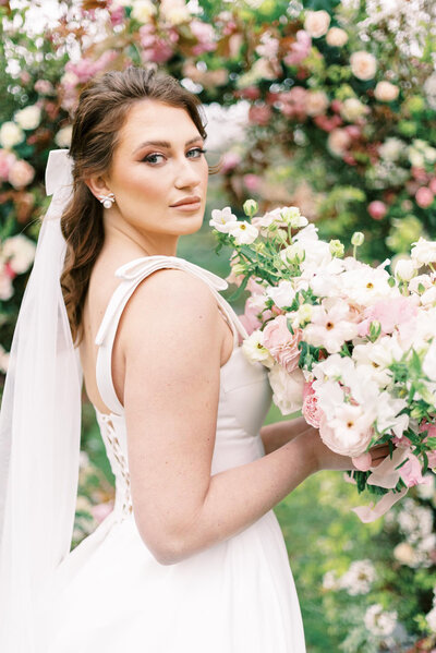 bride holding colourful bouquet