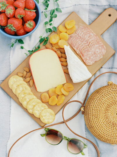 A summer charcuterie board with delicious cheese and strawberries was featured at this Aspen picnic.