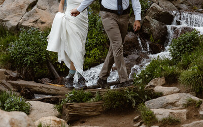 photo of bride and groom hiking in the mountains taken by Elopement photographer in ouray