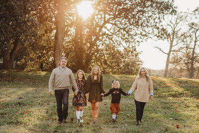 family in a field at sunset