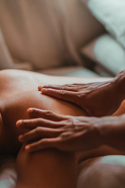 Massage therapist massaging client on their back