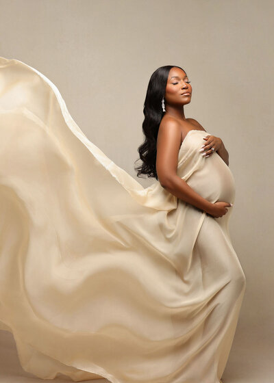 Romantic maternity portrait of partners hugging