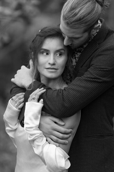 A man hugs a woman from behind