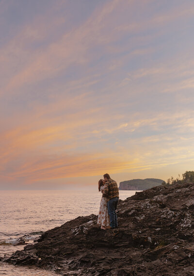 Engaged couple taking engagement photos at Tettegouche State Park in the North Shore of Minnesota