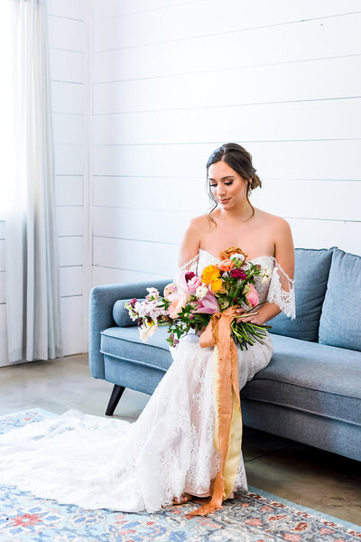Bride with bouquet in white bridal suite at georgia wedding venue