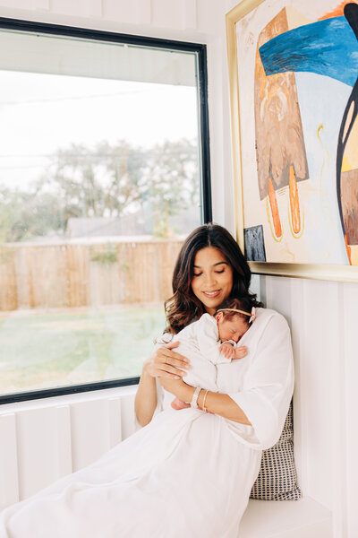 mother holding her newborn baby during a newborn session in Houston TX