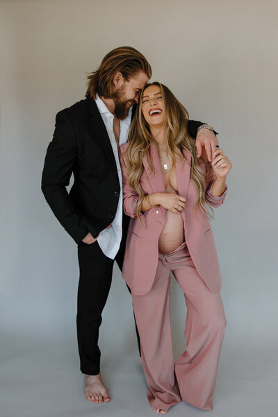 pretty-in-pink-maternity-shot-of-couple-laughing