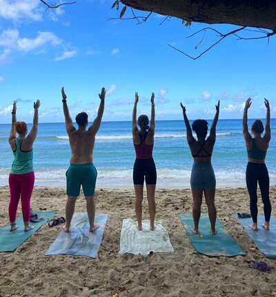 golden ray studio yoga classes being held on the beach