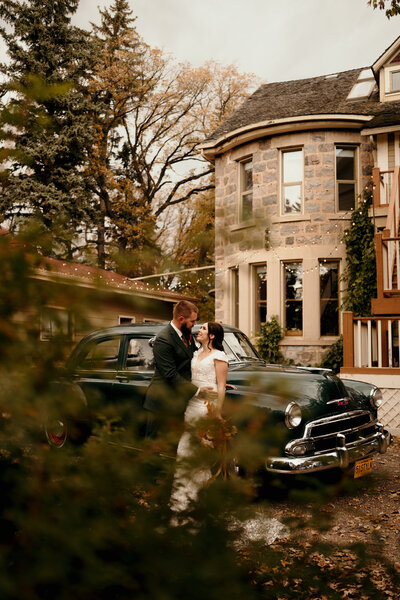 couple embracing by vintage car