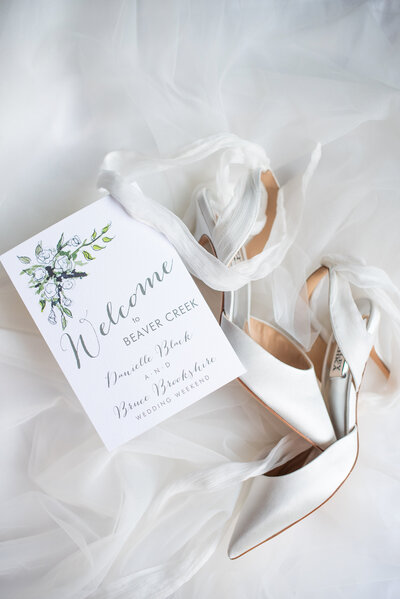 Bride's shoes and wedding invitation