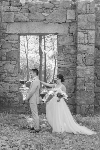 Bride tapping the shoulder of her groom for a first look