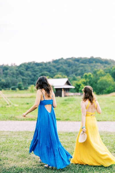 Colorfully dressed guests walk in the fields of Paint Rock Farm, photographed on 35 mm film by My Sun and Stars Co.