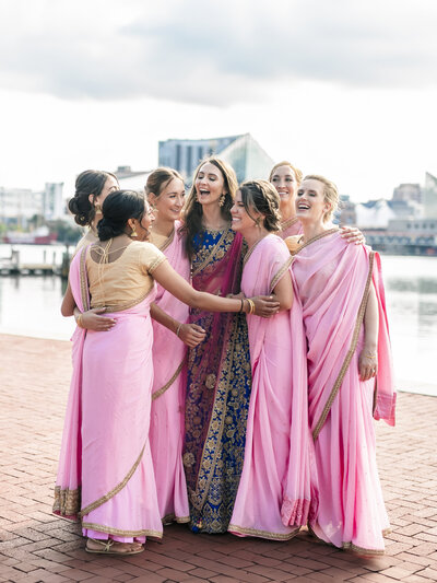 bridesmaids-hugging-bride-in-elegant-eastern-attire