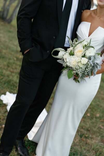 bride and groom at their wedding holding bouquet taken by east coast photographer