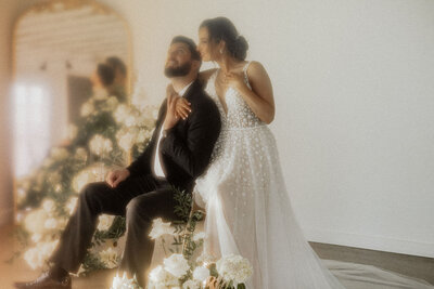 Bride and groom surrounded by flowers at The Sure Thing Chapel